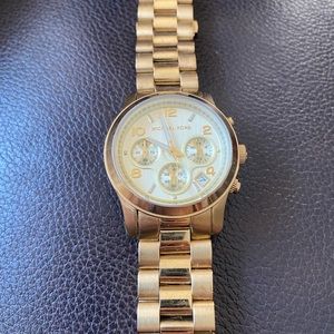 Michael Kors Gold Watch; sized for women m/l; links can be taken out